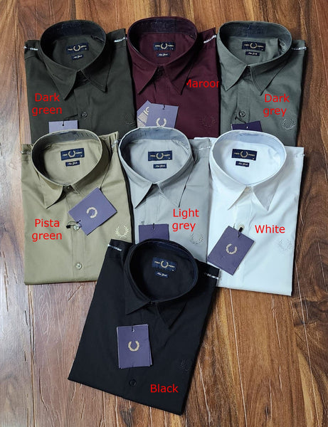 A black, long-sleeved button-up shirt with a collar and buttoned cuffs, featuring a branded logo-embroidery at the chest.